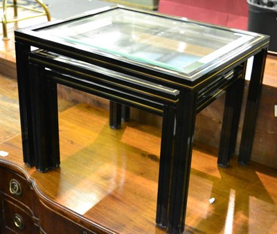 Lot 1306 - A nest of three black and gold rimmed occasional tables