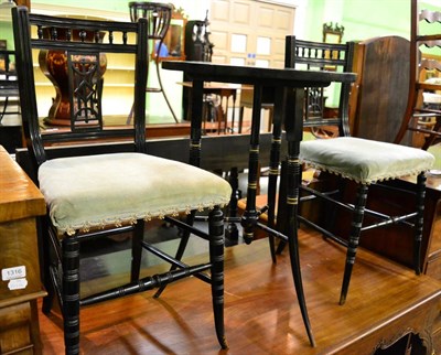 Lot 1314 - A pair of ebonised side chairs together with a late 19th century ebonised circular occasional table