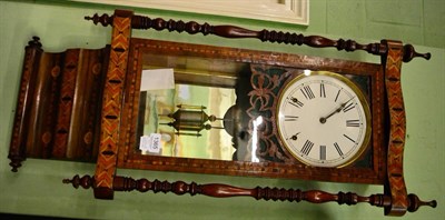 Lot 1365 - An inlaid striking wall clock