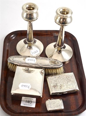 Lot 140 - A pair of silver candlesticks, a silver vesta, a cigarette case, a cigarette box and brush
