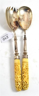 Lot 210 - A pair of early 20th century plated salad servers with carved ivory handles and silver mounts