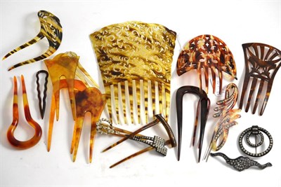 Lot 216 - A collection of mainly faux tortoiseshell hair combs and clips, including two pierced examples,...