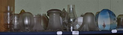 Lot 266 - A shelf of assorted glass shades including two Vaseline glass examples and another with pink...