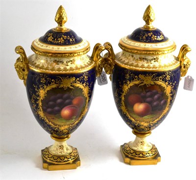 Lot 300 - A pair of fruit-painted Coalport vases and covers, by F.Howard with gilt ram handles and highlights