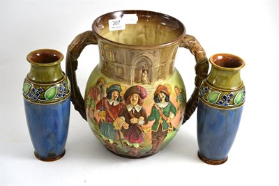 Lot 307 - Royal Doulton 'The Three Musketeers' two handled vase (cracked) and a pair of Doulton vases