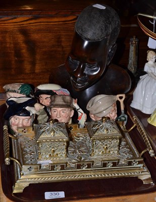 Lot 330 - Decorative brass inkstand, five Royal Doulton small character jugs and a carved ethnographic head