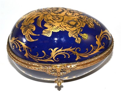 Lot 397 - A Sevres style gilt decorated egg casket