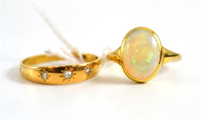 Lot 407 - An opal ring and a diamond three stone ring