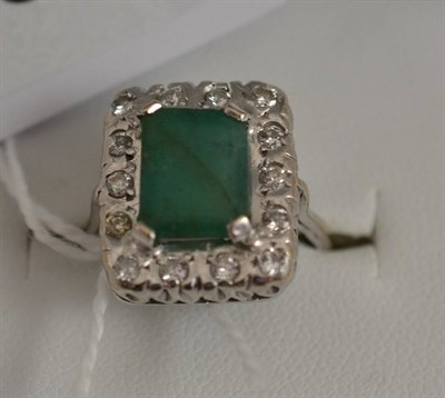 Lot 463 - An 18ct white gold emerald and diamond cluster ring