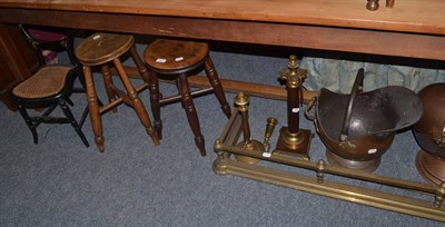 Lot 1021 - Two country stools, child's ebonised balloon back chair, brass fender, two coal hods, modern...