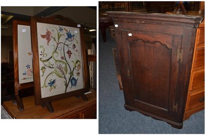 Lot 1030 - Georgian oak corner cupboard and two firescreens with embroidered inserts (3)