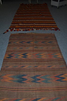 Lot 1046 - Afghan Kilim, the madder field with polychrome turreted bands, 257cm by 157cm; and a Balouch...