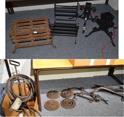 Lot 1069 - Two wrought iron Christmas tree stands, two fire baskets, assorted horse hanes, water bowl,...