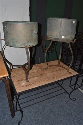 Lot 1070 - Wrought iron table and two plant stands with brass pots