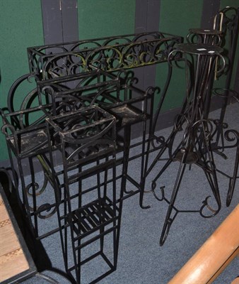 Lot 1071 - Four wrought iron planters, two torcheres, plant pot holder and a boot scraper (8)