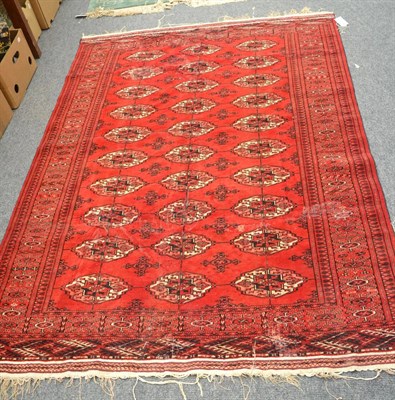 Lot 1073 - Tekke rug, North Afghanistan, the madder field with columns of quartered guls enclosed by...