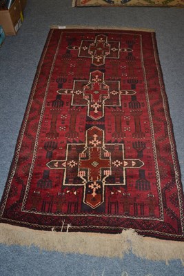 Lot 1077 - Balouch rug, West Afghanistan, the field with three cruciform medallions surrounded by ";Hands...