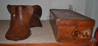 Lot 1106 - A Finigans brown leather suitcase with later repairs and a Kidson of Newmarket leather saddle