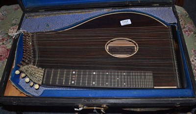 Lot 1107 - A wooden zither, with retailers label for 'Lewis Edward Mason York', with five bone tuners, in...