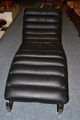 Lot 1122 - A modern black upholstered and chrome chaise