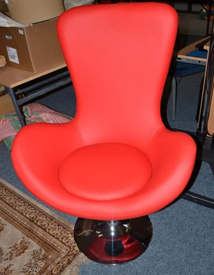 Lot 1123 - A modern red upholstered swivel chair