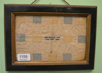 Lot 1159 - Early 19th century stitch sampler worked by Ann Bartram Cook 1807, in yellow and blue threads,...