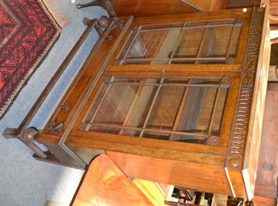 Lot 1217 - Carved oak bookcase on stand with glazed doors