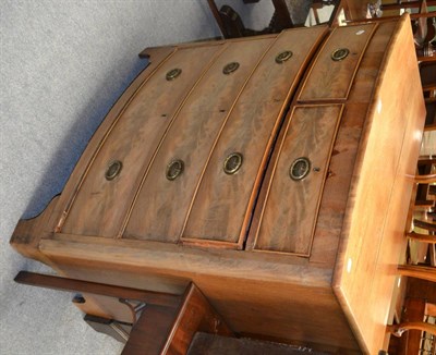 Lot 1225 - A figured mahogany bowfront chest of two short of three long drawers (faded)