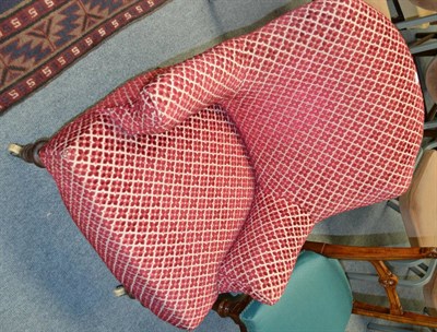 Lot 1265 - A Victorian tub shaped armchair upholstered in crimson floral moquette