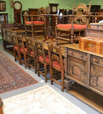 Lot 1284 - An oak dining suite in 17th century style, comprising dining table, twelve chairs, a dresser...