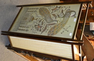 Lot 1287 - Late 19th century three leaf screen with Indian peacock embroidered panel