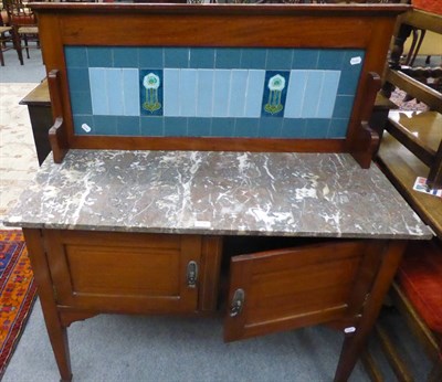 Lot 1290 - An early 20th century mahogany washstand with a marble top and a splash-back fitted with Art...