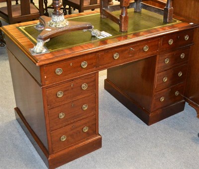 Lot 1299 - An Edwardian mahogany pedestal desk with green leather mount