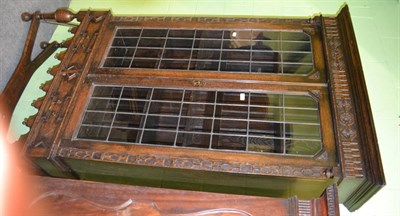 Lot 1317 - Oak glazed bookcase on stand with leaded glass doors