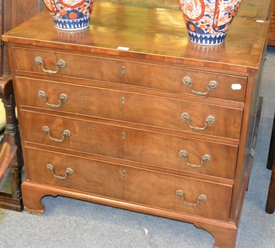 Lot 1328 - George III crossbanded mahogany straight front chest of four long drawers