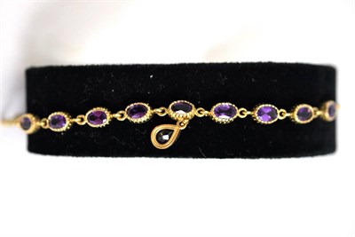 Lot 1 - A 9ct gold and amethyst necklace with nine stones and a drop