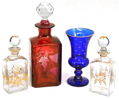 Lot 53 - A cranberry flanked decanter, two spirit or perfume flasks and stoppers and a cobalt vase