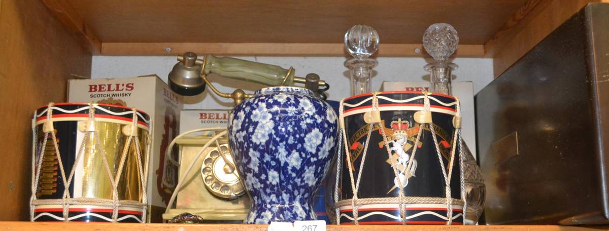 Lot 267 - Four Bells decanters (with contents), two regimental ice buckets in the form of drums, a set of...