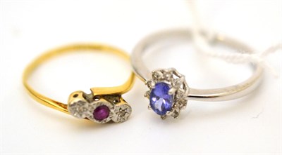 Lot 8 - A tanzanite and diamond cluster ring, stamped 'PT 950' and a ruby and diamond three stone twist...