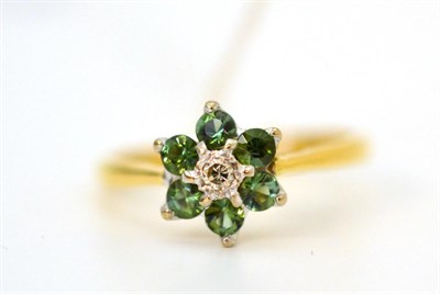 Lot 14 - An 18ct gold diamond and green stone cluster ring