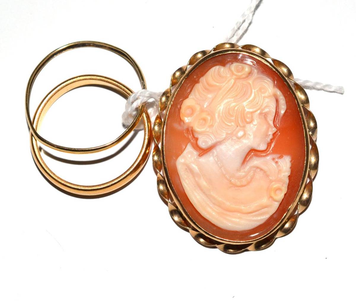 Lot 18 - A 22ct gold band ring, another band ring and a 9ct gold cameo brooch