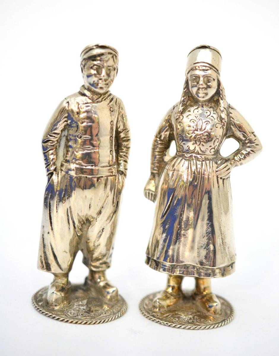 Lot 31 - A pair of 19th century Continental white metal pepperettes, modelled as a Dutch boy and girl in...