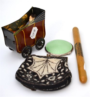 Lot 38 - Tin plate perambulator and doll, Victorian purse, Mauchline ware needle case and silver compact