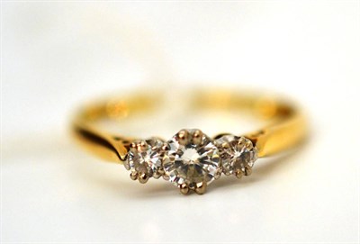 Lot 41 - A diamond three stone ring, the graduated round brilliant cut diamonds in white claw settings, to a