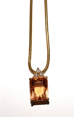 Lot 49 - A topaz pendant on chain, both stamped '750'