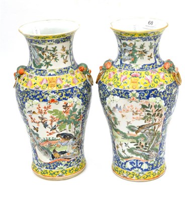 Lot 68 - Pair of 19th century famille rose yellow ground baluster vases, 34cm high