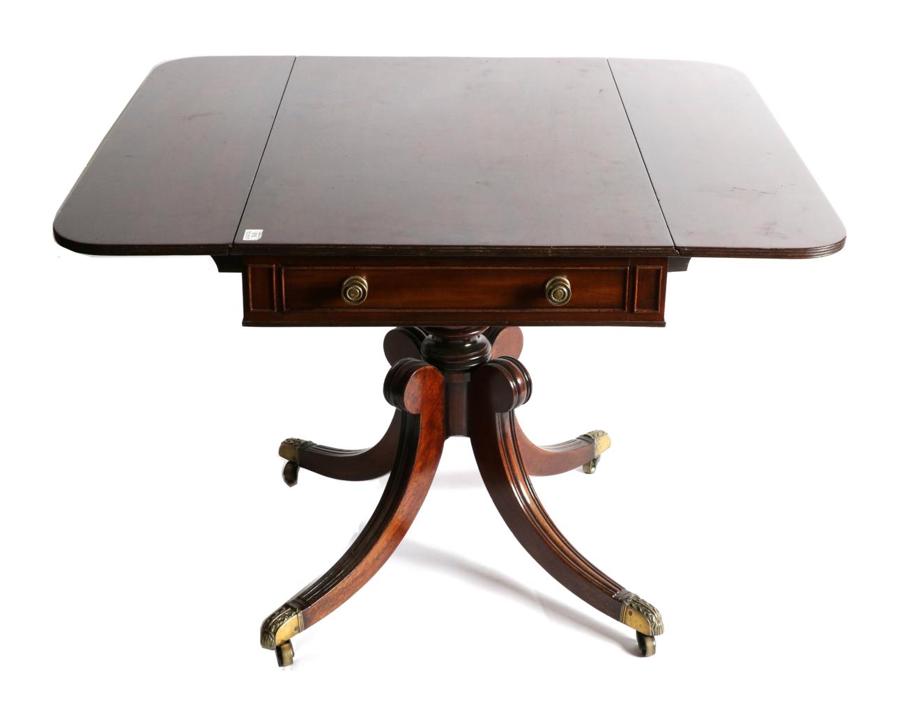 Lot 918 - A Regency Mahogany Dropleaf Sofa Table, early 19th century, with reeded edge above two frieze...
