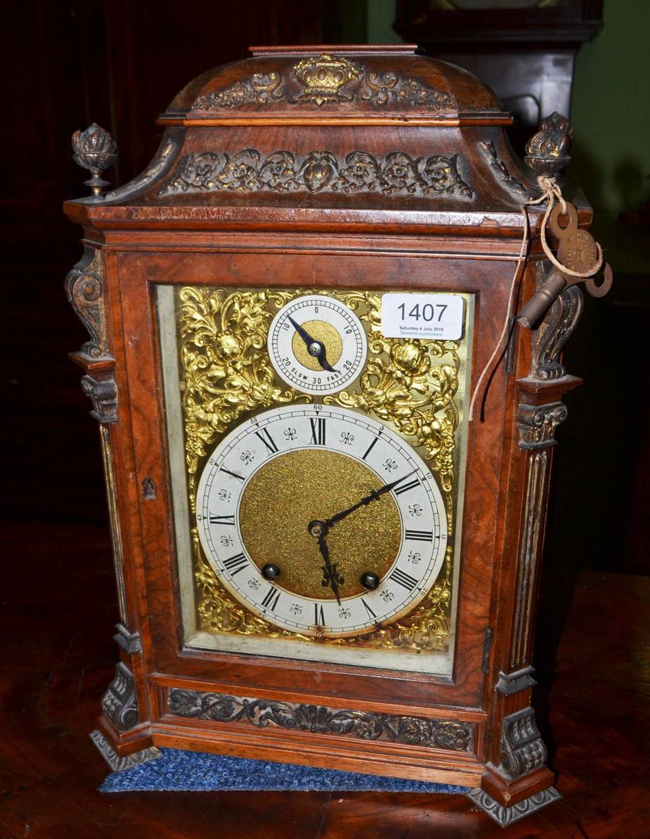 Lot 1407 - A German walnut caned bracket clock