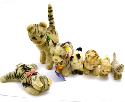 Lot 30 - Seven assorted Steiff tabby cat soft toys, seated and standing (two with jointed heads)