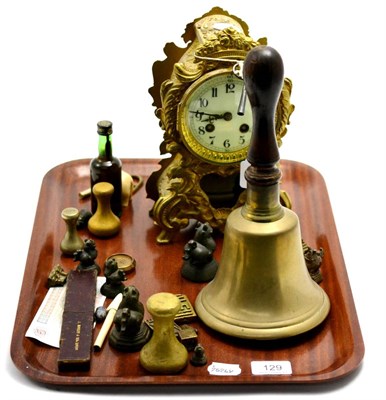 Lot 129 - Brass handbell, miniature bronzes, brass mounted mantel clock etc